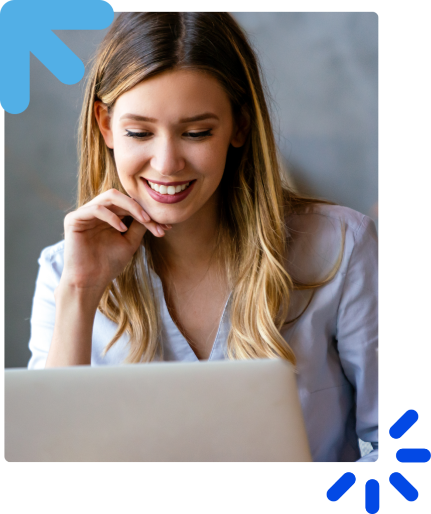 Smiling girl engaged with her laptop, working or browsing online