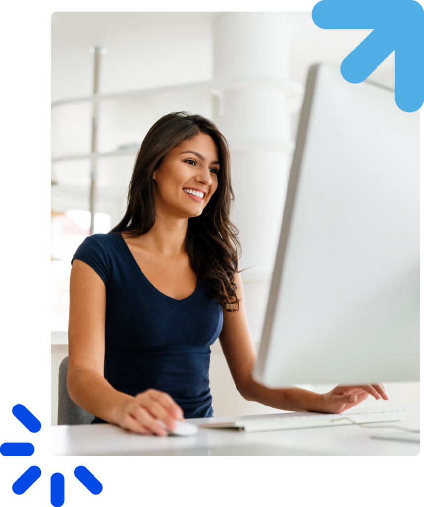 Cheerful girl using a computer and smiling in a bright environment