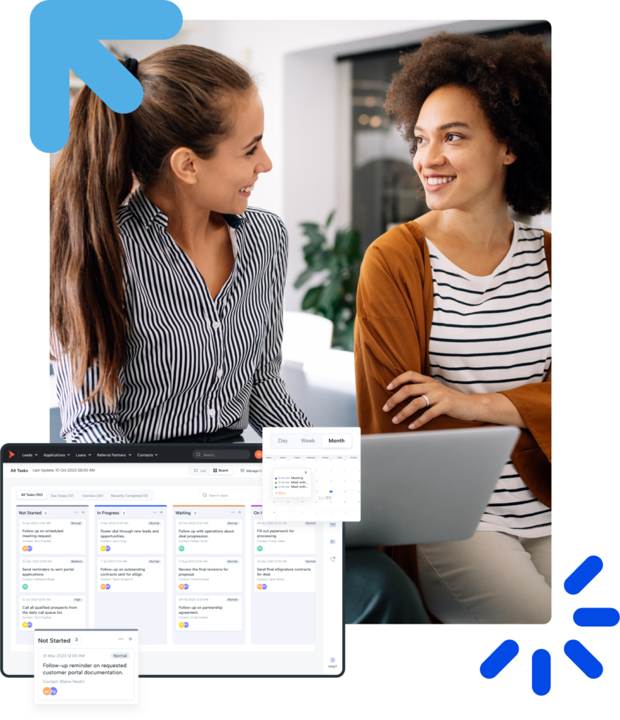 Two cheerful coworkers collaborating on a laptop during a productive office meeting